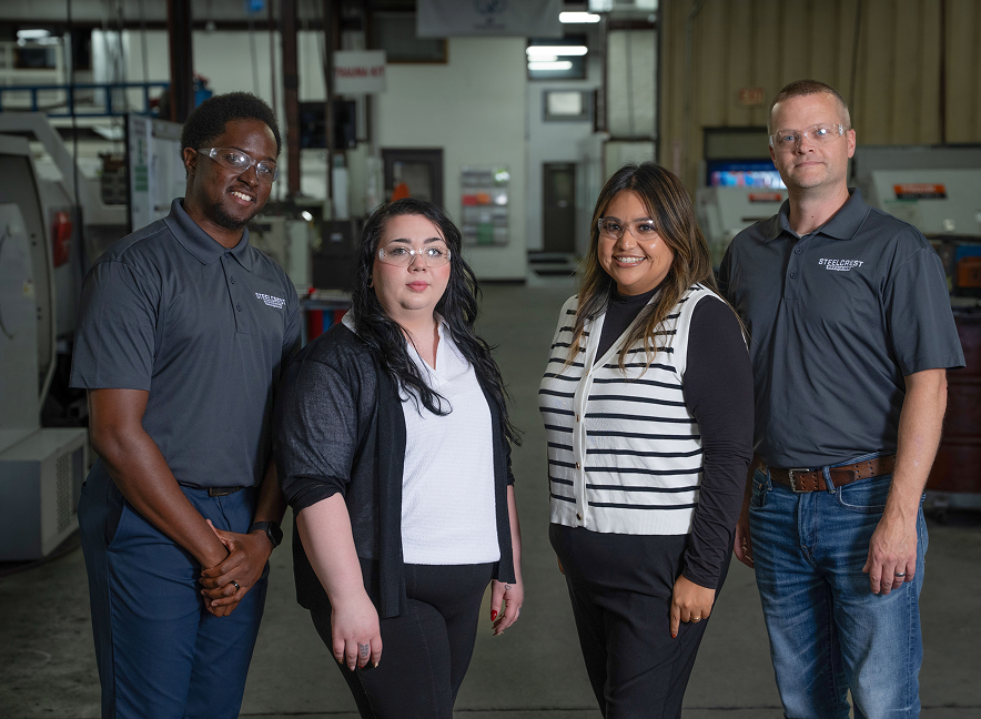 Team of precision machine and fabrication experts in a manufacturing setting